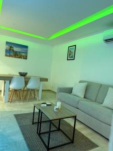 a living room with a couch and a table at Appartement Valeria in Saint-Laurent-du-Var