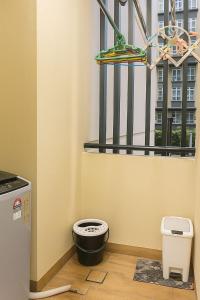a bathroom with a toilet in front of a window at Cozy City, Large studio stay for couple or family , Riverine Diamond in Kuching