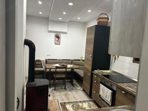 a kitchen with a table and a dining room at Vila Lush in Sarajevo +1 photo