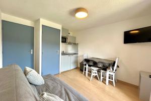 a living room with a table and a dining room at Au Pied des Neiges in Demi-Quartier