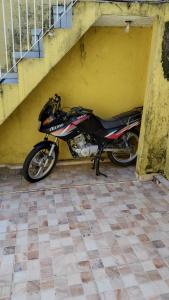 a motorcycle parked in a garage next to a yellow wall at Yellow Hostel in São Paulo