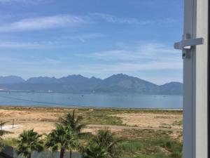 a view of the ocean and mountains from a house at Rosa Bayside Guesthouse in Da Nang