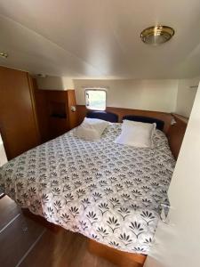 a bed in the center of a boat at Magnifique bateau au coeur du Nivernais à l'étang de BAYE in Bazolles