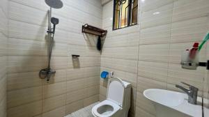 a bathroom with a toilet and a sink at Skill forest lodge in Arusha