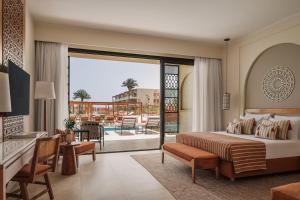 a hotel room with a bed and a balcony at Sakhra Hotel & Spa, Almaza Bay in Marsa Matruh +55 photos