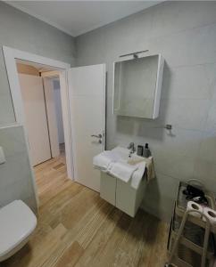 a bathroom with a white sink and a toilet at Apartments Ravlic in Neum +54 photos
