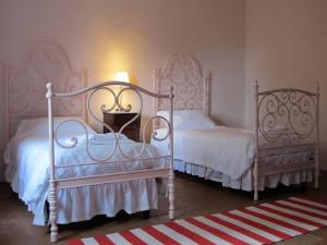 two beds sitting next to each other in a bedroom at Castello Sonnino in Montespertoli