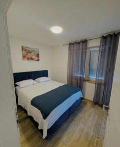 a bedroom with a large bed in a room at Apartments Ravlic in Neum