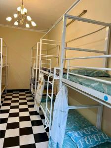 a room with bunk beds and a checkered floor at Hnhome28 in Hanoi +7 photos