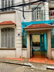 a building with a blue door and a porch at Hnhome28 in Hanoi