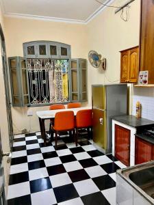 a kitchen with a black and white checkered floor at Hnhome28 in Hanoi
