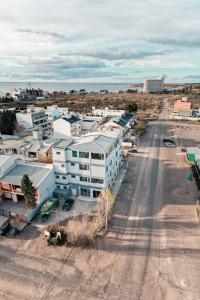 an aerial view of a city with a road and buildings at Rumel Quimey Quipan in Puerto Madryn