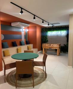 a dining room with a ping pong table and a ping pong table at Studio Alto Padrão Centro do Rio in Rio de Janeiro