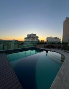 a swimming pool on the roof of a building at Studio Alto Padrão Centro do Rio in Rio de Janeiro