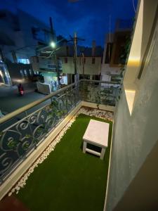 a table on a balcony with green grass at Heritage homestay in Puducherry
