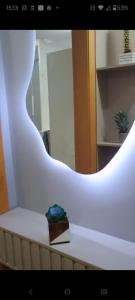 a white wall with a box on a table with a mirror at Studio Alto Padrão Centro do Rio in Rio de Janeiro +11 photos