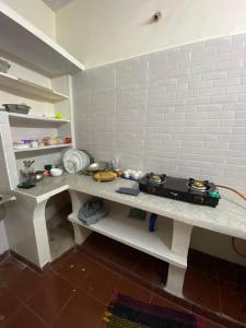 a kitchen with a table with aoustic at Heritage homestay in Puducherry +11 photos