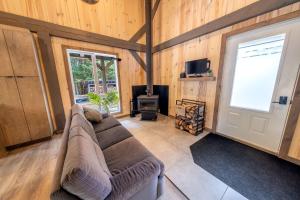 a living room with a couch and a fireplace at Spa and Nature - Chalet des Pins Rouge in Saint-Paul-de-Montminy +16 photos