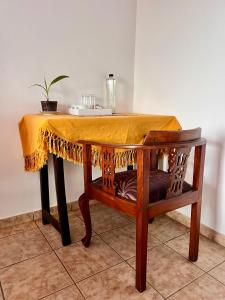 a table with a yellow table cloth on it at Ambiente Guest House in Ella +79 photos
