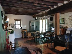 a living room with a table and chairs at la Vache chambre 1001 nuits in Les Guérigneaux