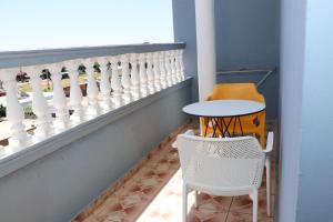 a balcony with a table and two chairs and a window at Kiki Hotel in Velipojë
