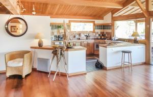 a kitchen with white cabinets and a wooden ceiling at Villa dans Site Exceptionnel in Mourèze +12 photos