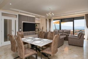 a dining room and living room with a table and chairs at Villa Boka in Tivat