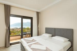 a bedroom with a bed and a large window at Villa Boka in Tivat +15 photos