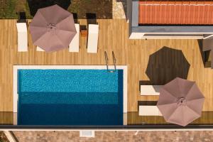 an overhead view of a table with umbrellas and a pool at Villa Boka in Tivat