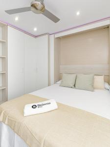 a bedroom with two beds with a white mattressvisor at La Cala-Flores Beach by Stay Belonio in Cala del Moral +18 photos