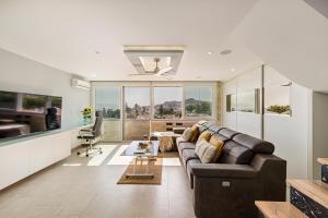 a living room with a couch and a table at La Cala-Flores Beach by Stay Belonio in Cala del Moral