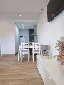 a kitchen and dining room with a table and chairs at Casa Machado in Cangas de Morrazo