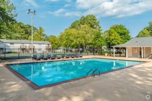 a large swimming pool with lounge chairs at Kenridge Apartments 1230 I Comfy 2 Bed 2 Bath in Decatur