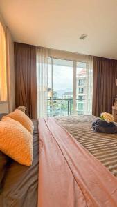 a bedroom with a bed with a large window at Nimman Condo,Mountain View in Chiang Mai +41 photos