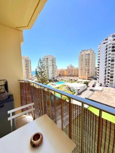 a balcony with a table and a view of a city at Casa da Praia na Torre Castelo in Armação de Pêra