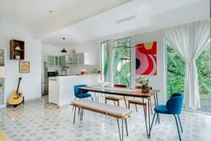 a kitchen and dining room with a table and chairs at Palette by RÊVE Escapes - Premium 2 BHK apartment Near Anjuna Beach in Assagao