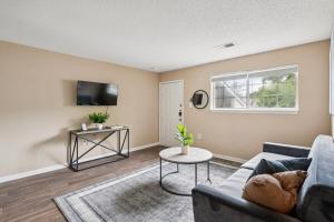 a living room with a couch and a tv at Kenridge Apartments 635 I Comfy 2 Bed 2 Bath in Decatur
