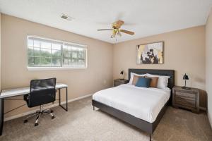 a bedroom with a bed and a desk and a window at Kenridge Apartments 635 I Comfy 2 Bed 2 Bath in Decatur +13 photos