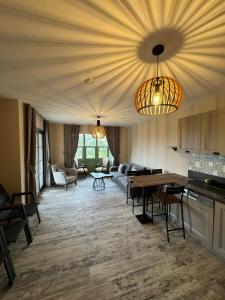 a kitchen and living room with a table and chairs at Valinor Urla in Urla