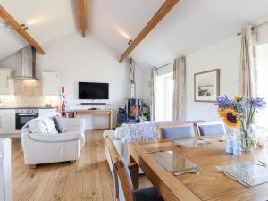 a living room with a couch and a table at Atlantic View in Tintagel