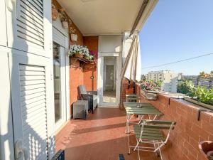 a balcony with chairs and tables on a building at Domus Laurentia in Rome
