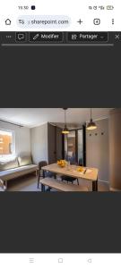 a screenshot of a room with a table and a kitchen at Mobil-home climatisé avec piscine in La Crau