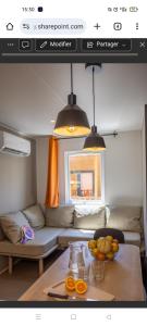 a living room with a table and a couch at Mobil-home climatisé avec piscine in La Crau +1 photo