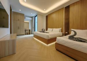 une chambre d'hôtel avec deux lits et un bureau dans l'établissement Bangtao Luxury Pool Villa - PrymaVerde, à Laguna Phuket 32 autres photos