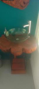 a bathroom with a sink with a wooden counter at Domos Temuco, Cumbres del Conunhuenu in Temuco