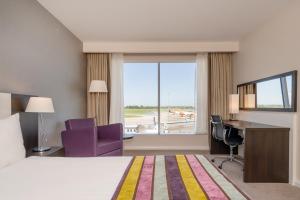 a hotel room with a bed and a desk and a window at Holiday Inn Southend by IHG in Southend-on-Sea +259 photos