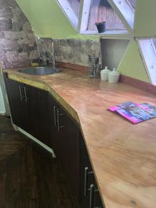 a kitchen with a sink and a wooden counter at Domos Temuco, Cumbres del Conunhuenu in Temuco +12 photos