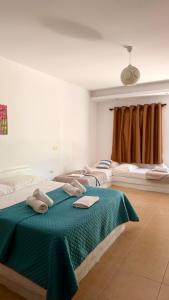 two beds in a room with towels on them at Rida Village Ksamil Island in Ksamil