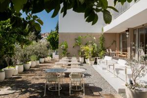 a courtyard with tables and chairs and potted plants at House Of Marmaris in Marmaris