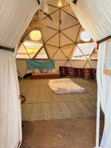 a room with a tent with a mattress in it at חוות רפאל - פרדס חנה in Mashabbe Sade